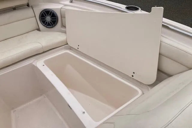 Slide: The Image of 2023 Grady-White Freedom 215 boat storage compartment with open lid and seating area. - 10