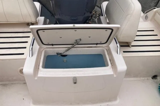 Slide: The Image of Open storage compartment on 2023 Grady-White Freedom 215 boat. - 12