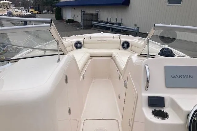 Slide: The Image of 2023 Grady-White Freedom 215 boat interior with Garmin navigation system and seating area. - 13