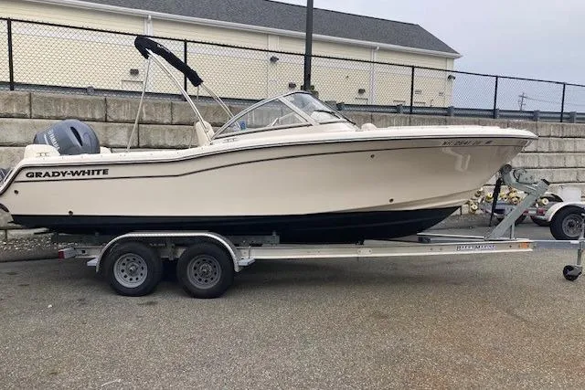 Slide: The Image of 2023 Grady-White Freedom 215 boat on trailer, parked outdoors. - 5