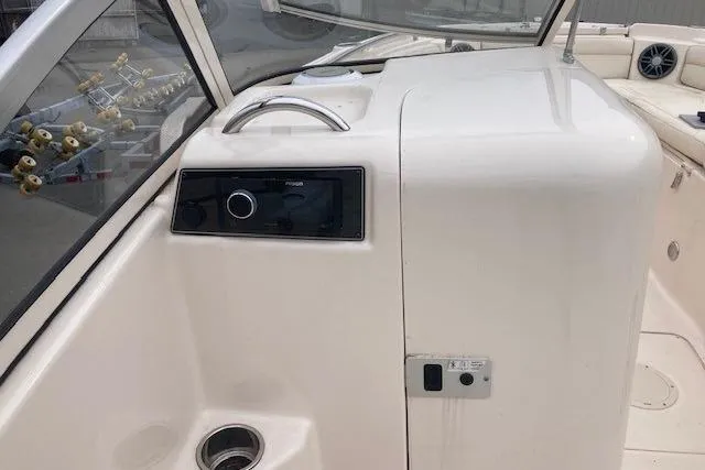 Slide: The Image of 2023 Grady-White Freedom 215 boat interior with control panel and seating area. - 8