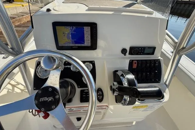 Slide: The Image of 2019 Mako 214 Center Console boat dashboard with steering wheel and navigation controls. - 12