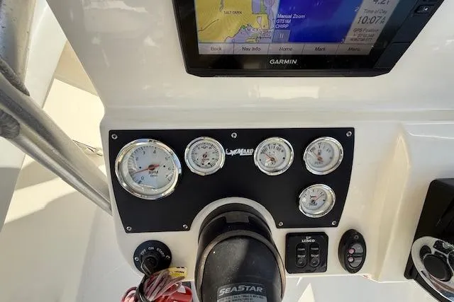 Slide: The Image of 2019 Mako 214 Center Console dashboard with Garmin display and gauges. - 13
