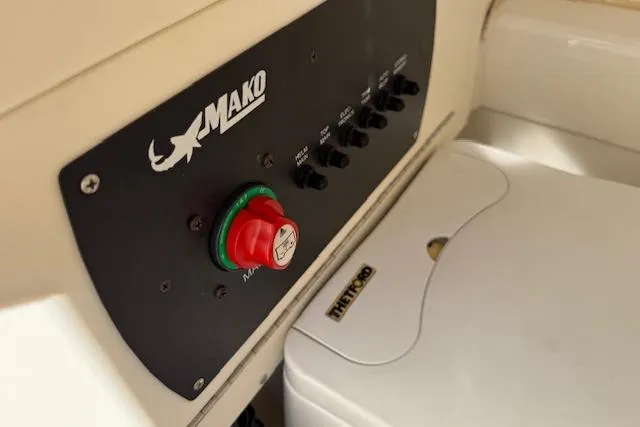 Slide: The Image of Control panel of a 2019 Mako 214 Center Console boat with switches and a red button. - 18