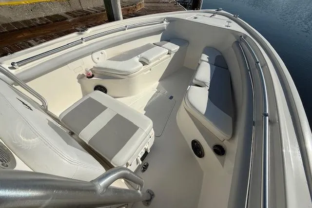 Slide: The Image of 2019 Mako 214 Center Console boat interior with cushioned seating and storage. - 20