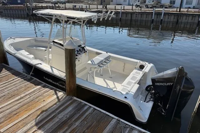 Slide: The Image of 2019 Mako 214 Center Console boat docked with Mercury engine. - 3