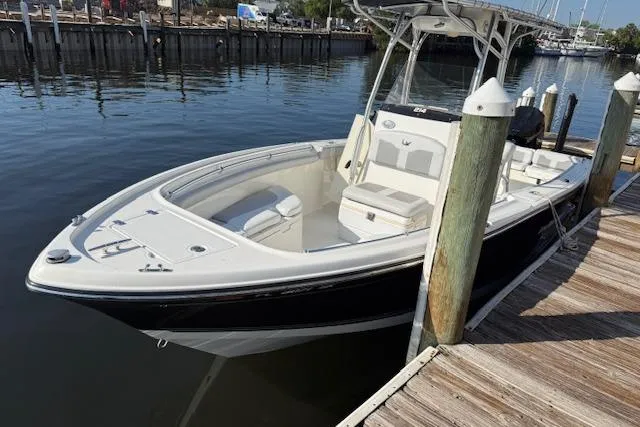 Slide: The Image of 2019 Mako 214 Center Console boat docked by the pier. - 4