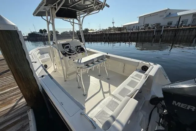 Slide: The Image of 2019 Mako 214 Center Console boat docked, featuring spacious seating and modern controls. - 5