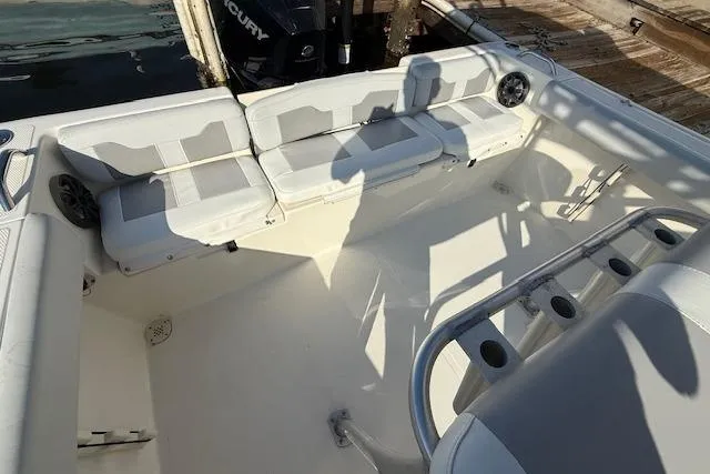Slide: The Image of 2019 Mako 214 Center Console boat interior with seating and rod holders. - 7
