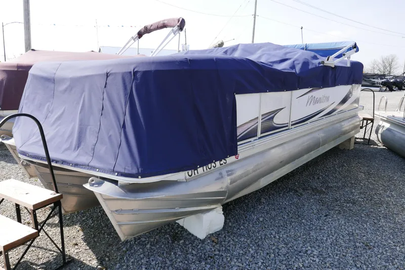 Slide: The Image of 2009 Manitou 20 Encore pontoon boat with blue cover on gravel lot. - 14