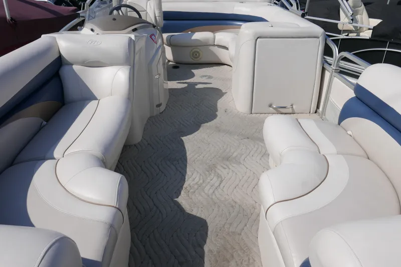 Slide: The Image of 2009 Manitou 20 Encore pontoon boat interior with white and blue seating. - 3