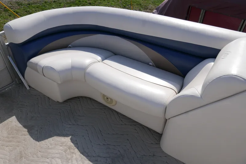 Slide: The Image of 2009 Manitou 20 Encore boat seating with white and blue upholstery. - 5