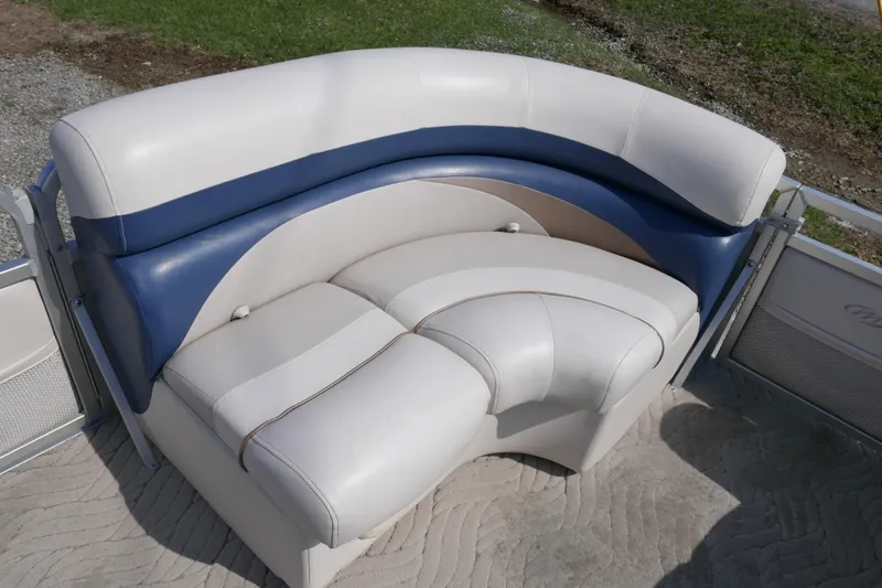 Slide: The Image of 2009 Manitou 20 Encore boat seating with blue and white upholstery. - 6