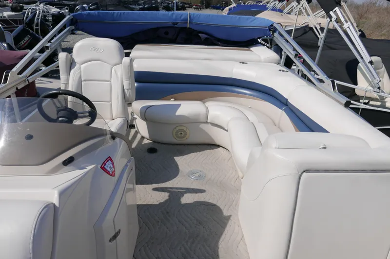 Slide: The Image of 2009 Manitou 20 Encore pontoon boat interior with white and blue seating. - 7