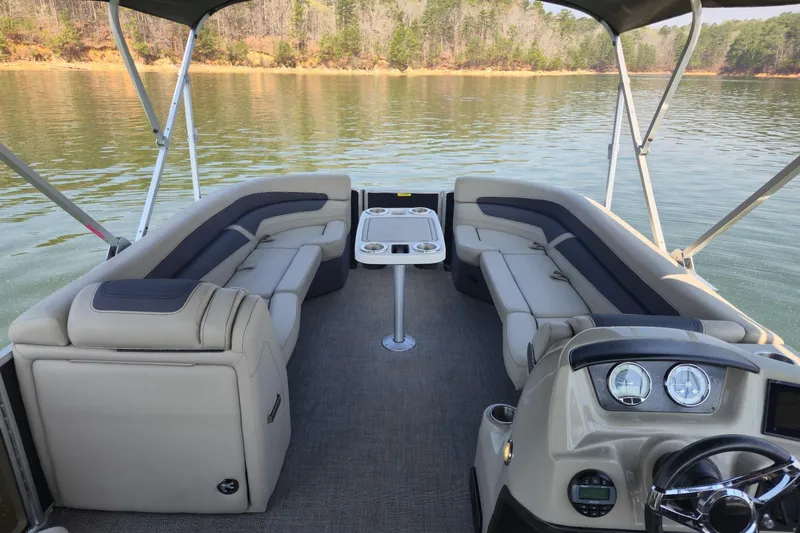 Slide: The Image of 2022 Barletta Cabrio 24UC pontoon boat interior with plush seating and scenic lake view. - 13