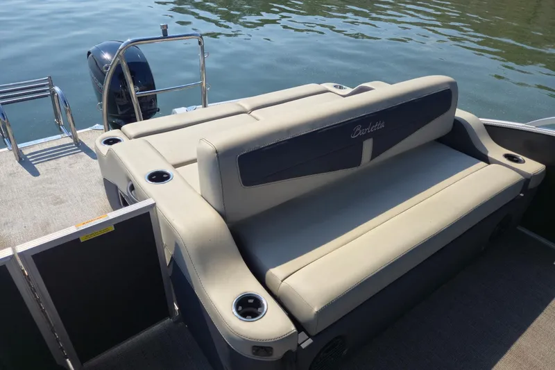 Slide: The Image of 2022 Barletta Cabrio 24UC pontoon boat with comfortable seating and cup holders. - 17