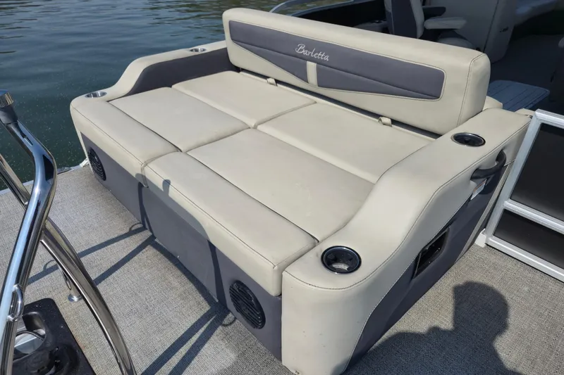 Slide: The Image of 2022 Barletta Cabrio 24UC boat seating with cup holders on a sunny day. - 18