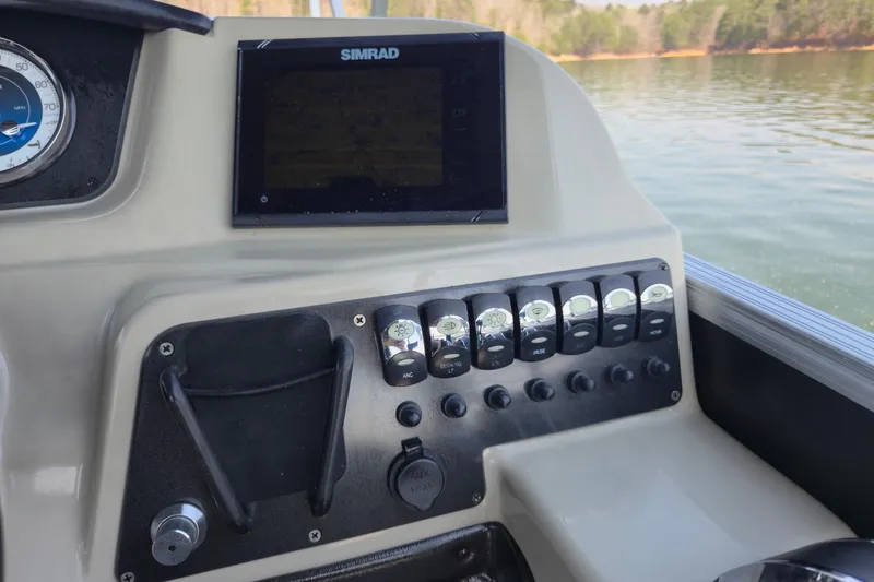 Slide: The Image of Control panel of 2022 Barletta Cabrio 24UC boat with Simrad display and switches. - 22