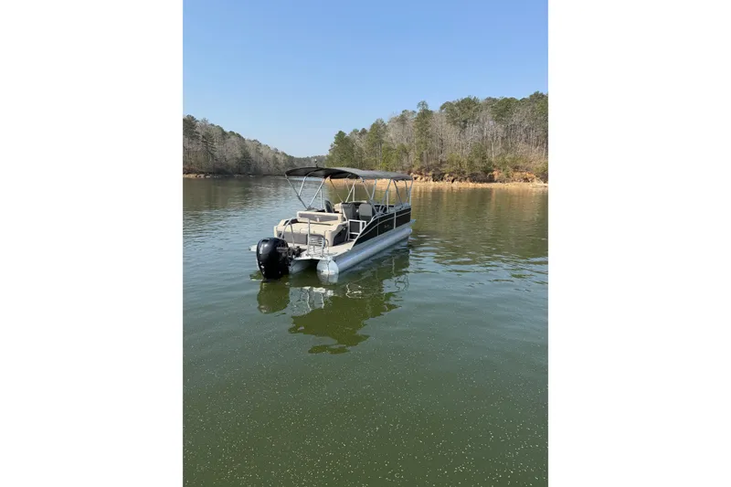 Slide: The Image of 2022 Barletta Cabrio 24UC pontoon boat on a serene lake. - 6