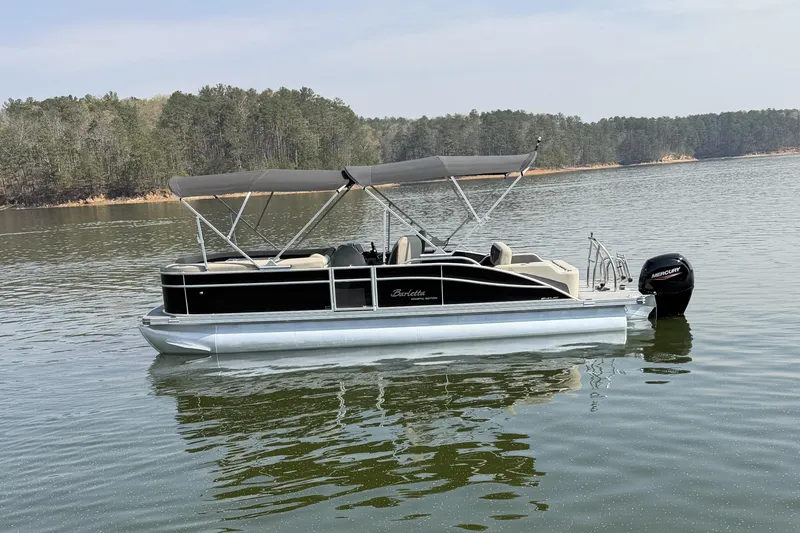 Slide: The Image of 2022 Barletta Cabrio 24UC pontoon boat on a calm lake. - 8