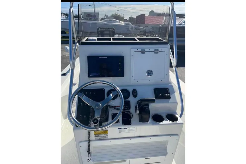 Slide: The Image of 2022 BayRider Kencraft 219 Bay boat console with steering wheel and navigation controls. - 12