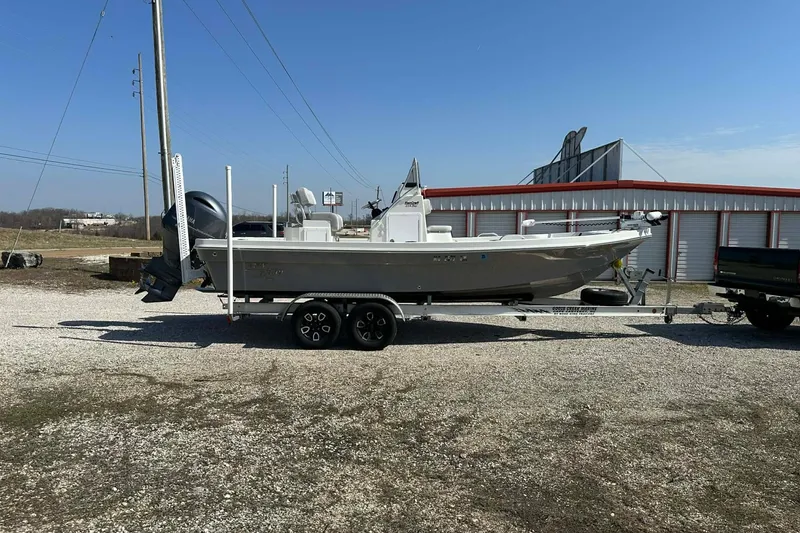 Slide: The Image of 2022 BayRider Kencraft 219 Bay boat on trailer, parked outdoors. - 13