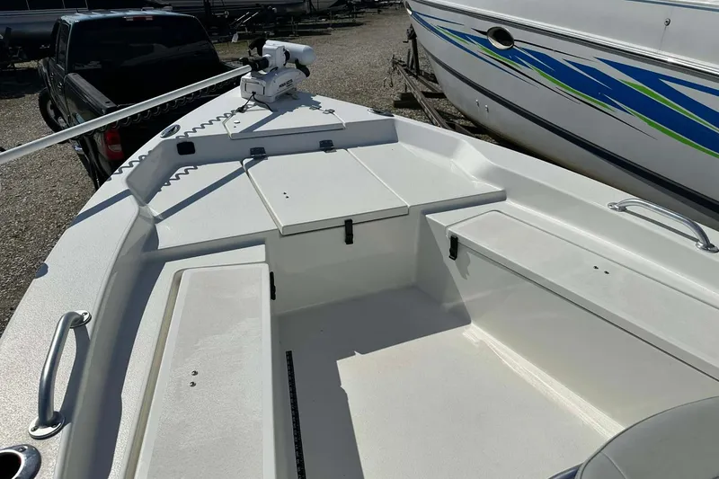 Slide: The Image of 2022 BayRider Kencraft 219 Bay boat deck with storage compartments and trolling motor. - 18