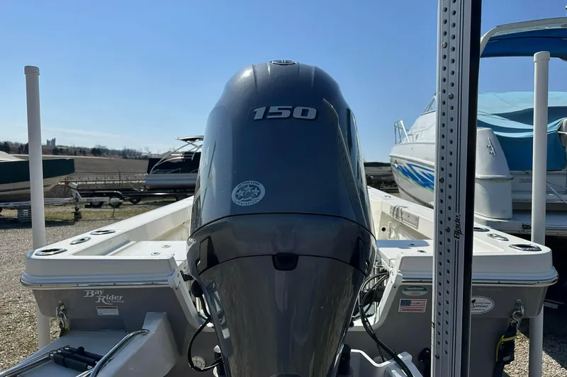 Slide: The Image of 2022 BayRider Kencraft 219 Bay boat with 150 horsepower engine, docked outdoors. - 26