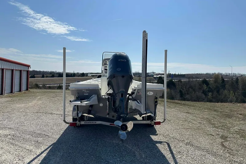 Slide: The Image of 2022 BayRider Kencraft 219 Bay boat on trailer, parked outdoors under clear sky. - 36