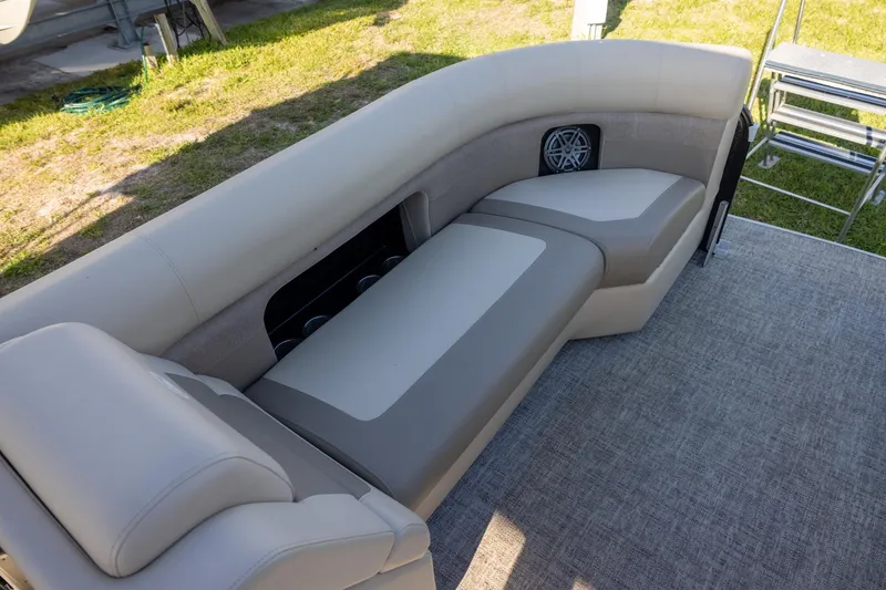 Slide: The Image of 2024 Premier 230 Sunsation RE boat interior with beige seating and speaker system. - 10