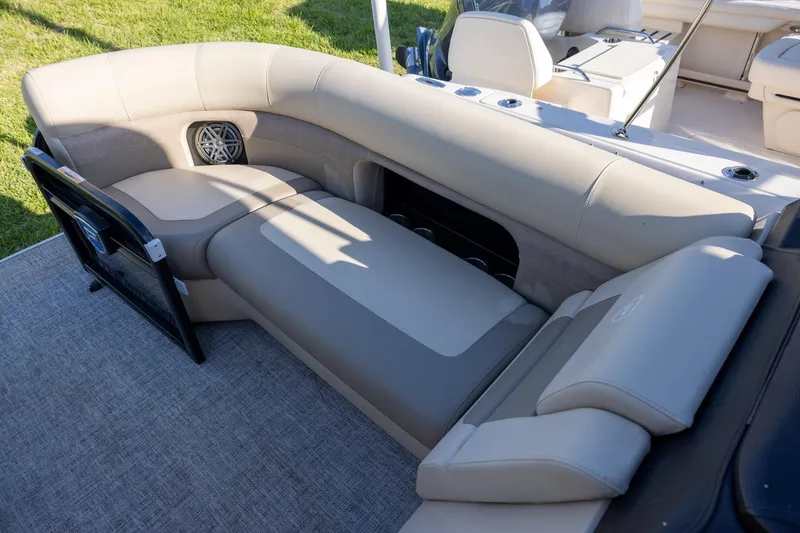 Slide: The Image of 2024 Premier 230 Sunsation RE pontoon boat interior with luxurious seating and canopy. - 11