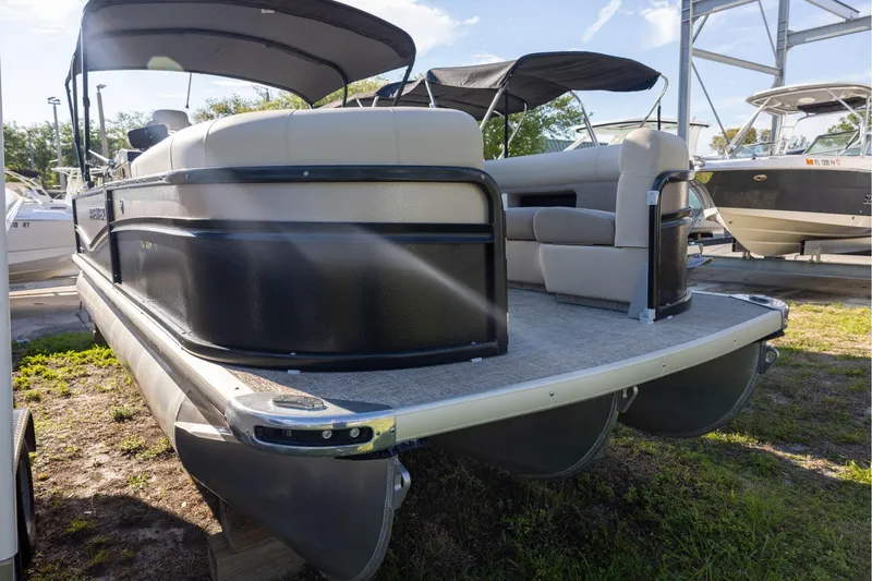Slide: The Image of 2024 Premier 230 Sunsation RE pontoon boat with Yamaha outboard motor, docked outdoors. - 2