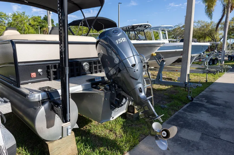 Slide: The Image of 2024 Premier 230 Sunsation RE pontoon boat interior with beige seating and table. - 4