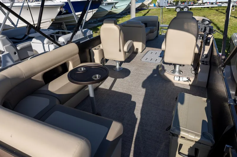 Slide: The Image of 2024 Premier 230 Sunsation RE boat interior with beige seating and round table. - 5