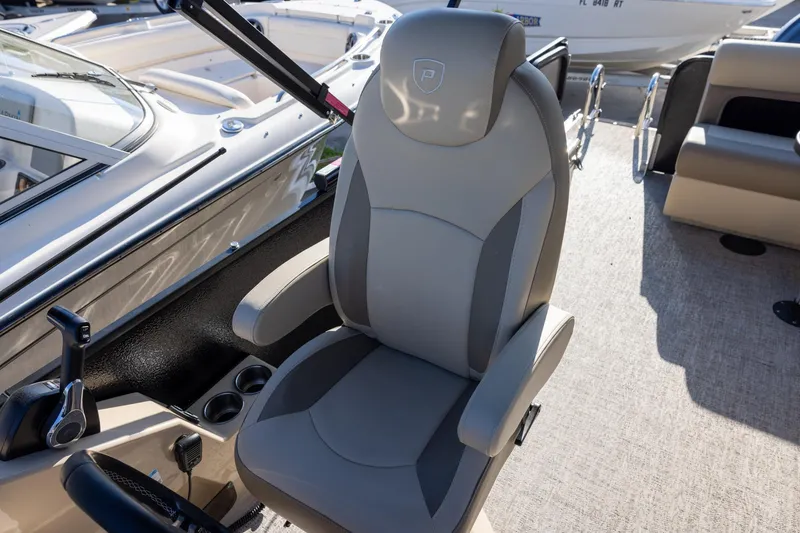 Slide: The Image of Luxurious seating on 2024 Premier 230 Sunsation RE pontoon boat with cup holders and table. - 8