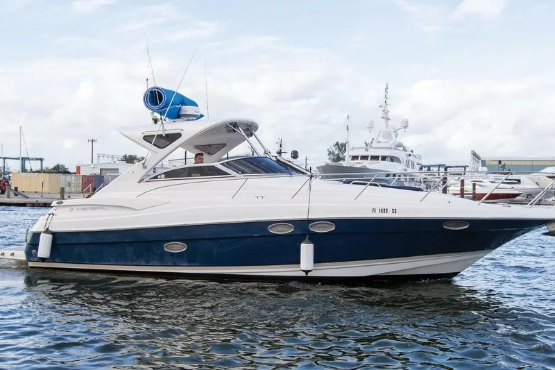 Slide: The Image of 2008 Regal 38 Express yacht cruising in a marina, showcasing sleek design and luxury features. - 0