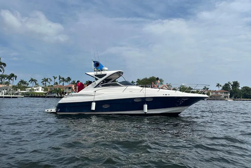 Slide: The Image of 2008 Regal 38 Express yacht cruising on a scenic waterway with passengers onboard. - 1