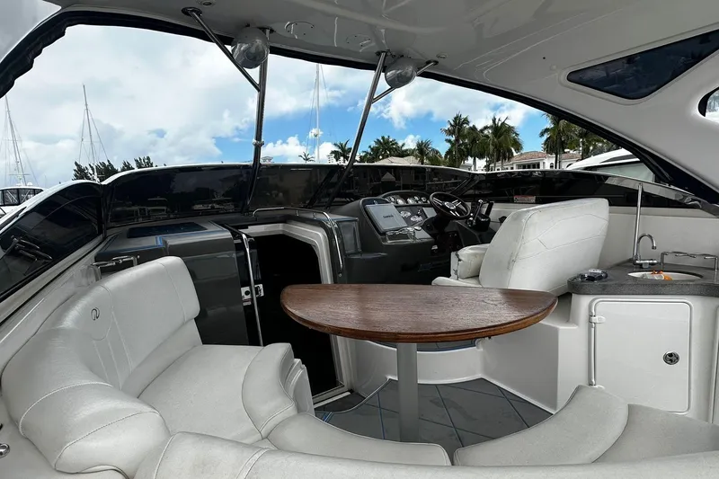 Slide: The Image of 2008 Regal 38 Express yacht interior with plush seating and wooden table. - 10