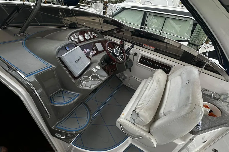 Slide: The Image of 2008 Regal 38 Express boat cockpit with Garmin navigation system and dual seating. - 11