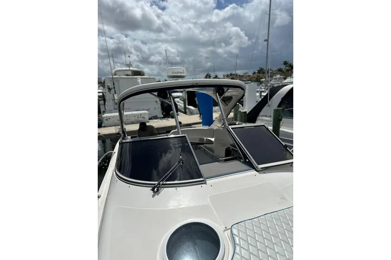 Slide: The Image of 2008 Regal 38 Express yacht docked under cloudy skies. - 13