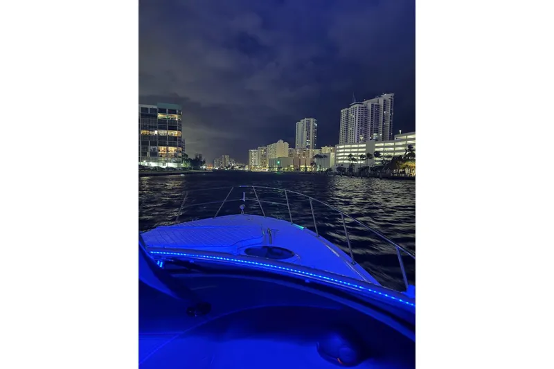 Slide: The Image of Night view from a 2008 Regal 38 Express boat, overlooking illuminated city skyline. - 17