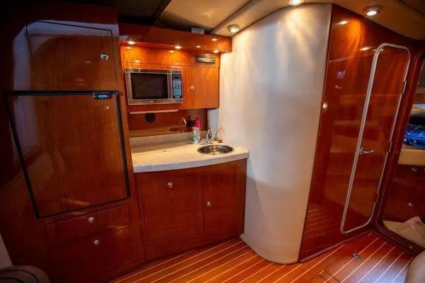 Slide: The Image of Luxurious 2008 Regal 38 Express yacht interior with kitchenette and wood finish. - 22