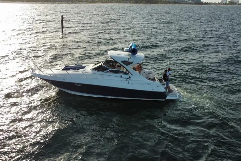 Slide: The Image of 2008 Regal 38 Express yacht cruising on open water with passengers onboard. - 3