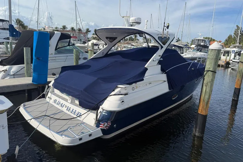 Slide: The Image of 2008 Regal 38 Express yacht docked at marina, covered with blue tarp. - 6