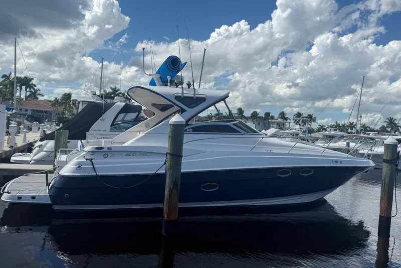 Slide: The Image of 2008 Regal 38 Express yacht docked at marina under cloudy sky. - 7