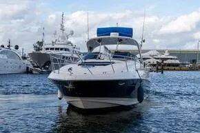 Slide: The Image of 2008 Regal 38 Express yacht docked in a marina, surrounded by other boats. - 8