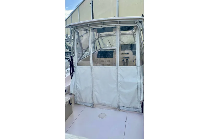 Slide: The Image of 2007 Grady-White Marlin 300 boat with enclosed cockpit and clear panels. - 11