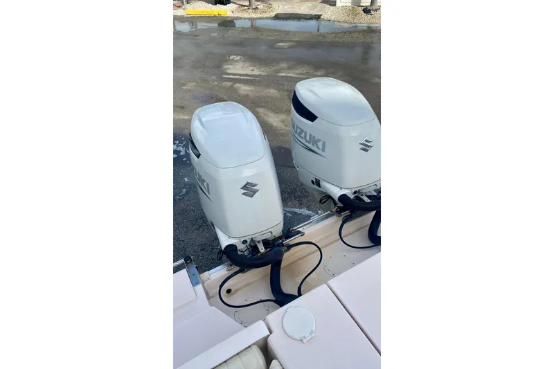 Slide: The Image of Twin Suzuki outboard motors on a 2007 Grady-White Marlin 300 boat. - 12