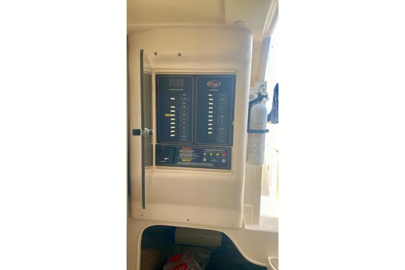Slide: The Image of Electrical panel inside a 2007 Grady-White Marlin 300 boat, featuring control switches and a fire extinguisher. - 5