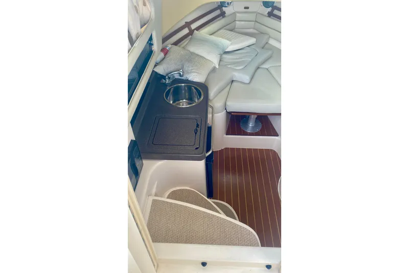 Slide: The Image of 2007 Grady-White Marlin 300 cabin interior with sink and cushioned seating area. - 8